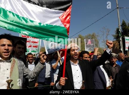 Sanaa, Sanaa, Yémen. 24 janvier 2024. Des manifestants brandissent des drapeaux palestiniens lors d'une manifestation contre les frappes aériennes soutenues menées par les États-Unis sur le Yémen, et en solidarité avec le peuple palestinien dans un conflit en cours entre Israël et le Hamas à Gaza.le porte-parole militaire houthi Yahya Saree a rapporté une confrontation entre leurs forces et plusieurs destroyers et navires de guerre américains dans le golfe d'Aden et Bab al-Mandab aujourd'hui. Les navires américains gardaient deux navires commerciaux, et pendant l'affrontement, l'un des navires américains a été frappé. En conséquence, les deux navires marchands américains ont été contraints Banque D'Images