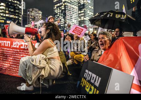 Israël. 24 janvier 2024. Les femmes israéliennes chantent alors qu'elles bloquent l'autoroute Ayalon à tel Aviv lors d'une manifestation pour demander un accord immédiat sur les otages et un cessez-le-feu. 136 otages israéliens sont toujours détenus en captivité par le Hamas à Gaza, dans des conditions potentiellement mortelles, après avoir été pris en otage lors de l'attaque du 7 octobre. Tel Aviv, Israël. 24 janvier 2024. (Matan Golan/Sipa USA). Crédit : SIPA USA/Alamy Live News Banque D'Images