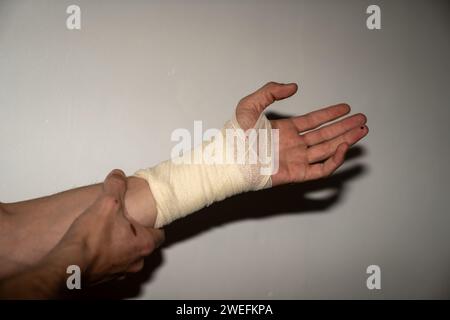 Blessure masculine à la main gauche avec bandage Banque D'Images