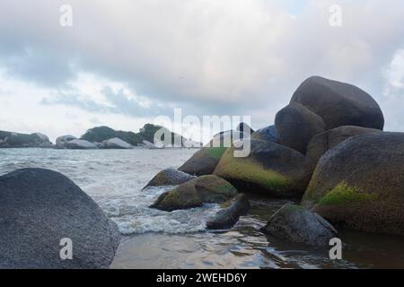 Gros rochers moussseux sur le rivage de la plage d'arrecife à l'intérieur du parc national colombien tayrona Banque D'Images