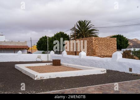 Une vue sereine sur le terrain Ermita de San Marcos avec une structure en pierre et des palmiers. Banque D'Images