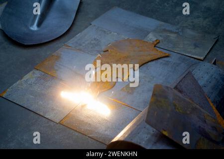 Laser cleaning of metal. The laser beam cleans the metal surface from rust. Laser removes removing old rust from metal. Innovation metalworking. New technologies Stock Photo