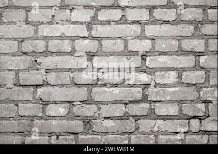 Gros plan du mur de briques plat avec des rangées de briques de béton de ciment comme arrière-plan Banque D'Images