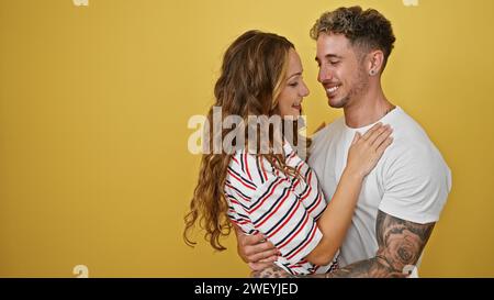 Couple affectueux embrassant sur un fond jaune, signifiant amour et unité. Banque D'Images