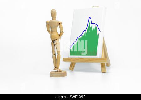 Mannequin dessinant des graphiques sur chevalet ; isolé sur fond blanc ; concept d'affaires ou de finance Banque D'Images