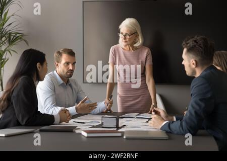 Femme chef principale du groupe d'affaires debout à la table de réunion Banque D'Images