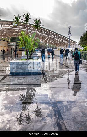 Les gens marchent près de la gare un jour de pluie Banque D'Images