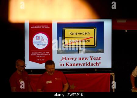 Kirchweidach, Allemagne. 28 janvier 2024. Football : Bundesliga, FC Bayern Munich. Un panneau avec l'inscription 'Harry New Year in Kaneweidach' accueille le joueur du FC Bayern Harry Kane d'Angleterre lors de sa visite au fan club 'Die Roten' à Kirchweidach. Il a reçu un trophée pour sa victoire dans un mini-olympique bavarois sous la forme d'une couronne de buteur de buts, qu'il pouvait également utiliser pour profiter du tabac à priser. Les stars du FC Bayern ont compensé leurs visites au fan club, qui avaient été reportées en décembre en raison de la météo hivernale. Crédit : -/Jens Niering/dpa/Alamy Live News Banque D'Images