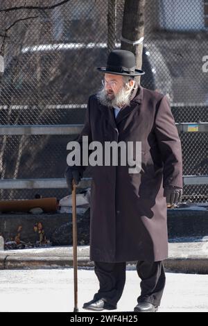 Un juif orthodoxe plus âgé marche avec une canne sur le passage supérieur de BQE, Lee Avenue, Williamsburg. Début 2024. Banque D'Images