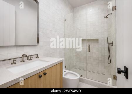 Lavabo blanc et douche dans la cabine de la salle de bains Banque D'Images