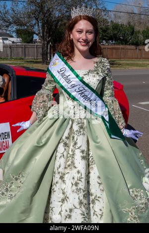 Jolie rousse, duchesse de miellat, pose en robe vert clair élaborée à la 92e édition annuelle de Texas Citrus Fiesta Parade of oranges, Mission, Texas, USA. Banque D'Images