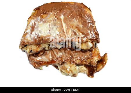 Une pâte à tarte cuite recouverte de sauce au chocolat et farcie de morceaux de chocolat, de morceaux de biscuit, de banane, de gâteau, de caramel et de chocolat noisette crea Banque D'Images