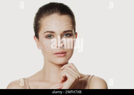 Les lignes graphiques montrent l'effet de lifting du visage sur le visage jeune femme Banque D'Images