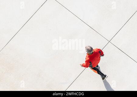 Homme senior jogging le long d'un chemin de la ville. Concept de mode de vie sain. Espace de copie. Vue aérienne Banque D'Images