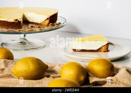 Cheesecake au mascarpone avec caillé de citron et base de sablé. Fond de marbre blanc. Photo de nourriture haute touche Banque D'Images