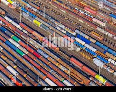 Deutsche Bahn AG marshalling yard. Many goods trains are parked on the tracks with tank wagons, car transporters and other wagons, companies Stock Photo