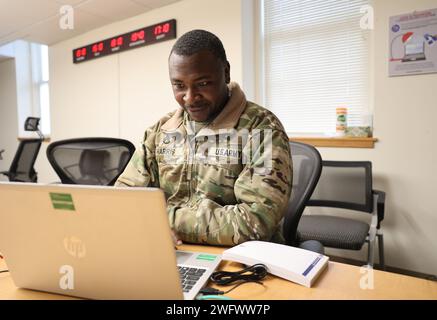 Le Sgt. Vincent Harris, G6 gestion de contenu NCOIC, 1st Theater Sustainment Command, travaille sur un ordinateur, le 24 janvier 2024, à fort KNOX, Kentucky. Banque D'Images