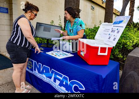 PEARL CITY, Hawaii – Un officier de liaison communautaire du Naval Facilities Engineering Command Hawaii, à droite, partage des informations sur le programme de surveillance à long terme de l’eau potable de la Marine avec un résident d’Hawaii au minimart de Pearl City Peninsula Navy Exchange à Pearl City, Hawaii, le 11 janvier 2024. La Marine accueille le kiosque mensuel à divers endroits pour tenir le public informé sur le programme et sur la façon de lire les résultats sur l'eau potable sur le site Web joint base Pearl Harbor-Hickam Safe Waters. Banque D'Images