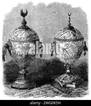 L'exposition internationale : coupes faites d'oeufs d'autruche, à la Cour algérienne, 1862. « Les coupes que nous gravons peuvent être classées parmi les œuvres curieuses qui auront rarement l'occasion de voir. Formés d'oeufs d'autruche, ils sont beaux dans la forme ; et, si l'on ne peut pas dire grand-chose en faveur de l'ornement qui est sculpté sur la coquille, les montures en filigrane en or et en argent sont très beaux. Pittoresques en apparence et uniques en aspect, ces tasses apparaissent dans l'exposition comme des objets d'intérêt, dans le coin sud-est isolé de la Cour française. Extrait de "Illustrated London News&quot Banque D'Images