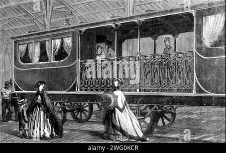 L'exposition internationale : wagon de première classe belge, avec salon fumeur attaché - d'après une photographie de la London Stereoscopic Company, 1862. Un wagon '...composite, composé de deux compartiments de première classe placés à chaque extrémité, avec une cloison couverte au centre, mais ouverte sur les côtés. Les entrées des saloons se font à partir de la division ouverte au milieu ; une rampe ouverte est placée de chaque côté de la partie centrale, et l'entrée principale de la voiture se trouve dans celle-ci. A la faible vitesse que la plupart des trains voyagent sur le continent, nous pouvons facilement imaginer cet arrangement à b Banque D'Images