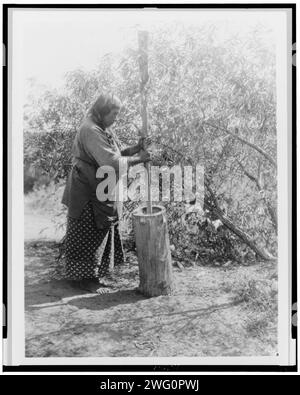 Mortier de Wichita, c1927. Wichita femme utilisant mortier et pilon. Banque D'Images