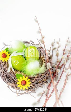 Vie morte de Pâques. Oeufs décorés de Pâques dans un nid avec un bouquet de saule. Composition avec oeufs de Pâques et saule. Concept Spring Flower. Banque D'Images