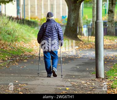 Glasgow, Écosse, Royaume-Uni. 3 février 2024. UK Météo : une journée ennuyeuse a vu des habitants dans les rues du centre-ville.Old person marche avec des bâtons de marche. Crédit Gerard Ferry/Alamy Live News Banque D'Images