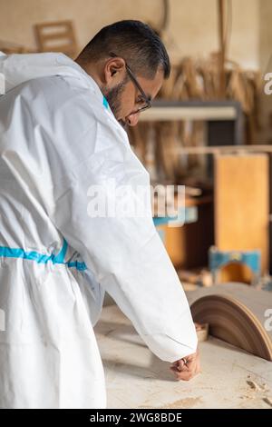 homme dans l'intérieur de menuiserie travaillant avec des machines et le style de vie, occupation professionnelle, ponçage du bois pour construire des meubles, artisan Banque D'Images