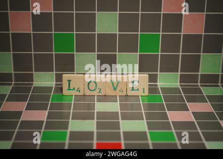 Tuile en bois avec texte d'amour vert sur un fond bloqué Banque D'Images