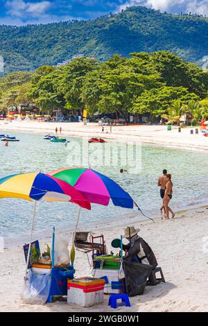 Vendeur et parasol sur la plage de Chaweng, Ko Samui, Thaïlande Banque D'Images