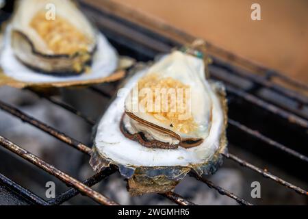 Huîtres à l'ail grillées au charbon de bois sucrées et délicieuses Banque D'Images