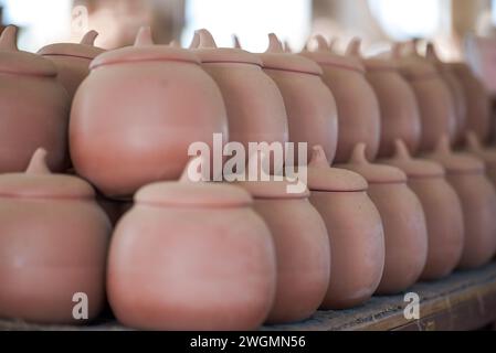 Embryons d'argile soigneusement empilés et moules dans une usine de poterie chinoise traditionnelle Banque D'Images