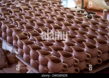 Embryons d'argile soigneusement empilés et moules dans une usine de poterie chinoise traditionnelle Banque D'Images