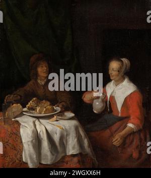 Homme et femme au repas, Gabriël Metsu, 1650 - 1660 peinture homme et femme au repas. Un homme et une femme sont assis à une table fixe. L'homme attrape un verre, la femme verse d'une cruche dans un verre haut. Sur la table une assiette avec un jambon, du fromage et du pain. toile. panneau. coulage de peinture à l'huile (peinture). pain, pain. table posée : vaisselle, décoration de table, etc Banque D'Images