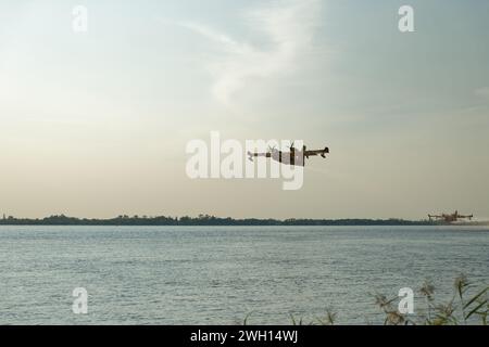 Canadairs du pompier en vol, se remplissant d'eau, sur la rivière Dordogne en Gironde Banque D'Images