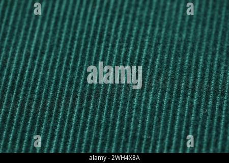 Texture du tissu tricoté vert foncé doux comme fond, gros plan Banque D'Images