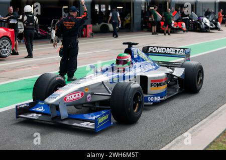 Une voiture de formule 1 Minardi M198 de 1999 qui descend la Pit Lane internationale lors de la démonstration du 75e anniversaire du Grand Prix à Silverstone Banque D'Images