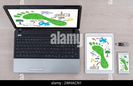 Concept d'empreinte carbone montré sur différents appareils de technologie de l'information Banque D'Images