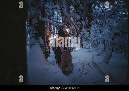 Randonnée familiale aux flambeaux en hiver Banque D'Images