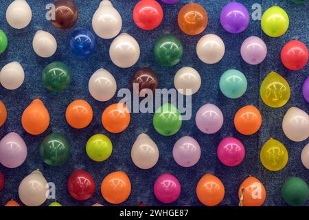 Ballons colorés qui doivent être frappés avec des flèches de fléchettes, lancer le jeu au carnaval de foire, plein cadre arrière-plan Banque D'Images