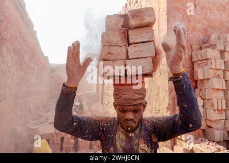 Narayanganj, Bangladesh. 10 février 2024. Des hommes bangladais travaillent dans un champ de briques à Narayanganj, Bangladesh, 10 février 2024. L'émission d'une énorme quantité d'éléments toxiques provenant des fours à briques entraîne de graves risques pour la santé des travailleurs et des personnes vivant dans les zones environnantes, la plupart souffrant de problèmes respiratoires ou cutanés. Les travailleurs dans ce domaine de la brique gagnent moins de 5 $ par jour. (Crédit image : © Suvra Kanti Das/ZUMA Press Wire) USAGE ÉDITORIAL SEULEMENT! Non destiné à UN USAGE commercial ! Banque D'Images