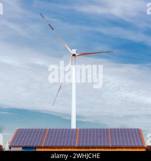 Panneaux solaires sur un toit et une éolienne dans un champ. Centrale solaire. concept d'économie d'énergie Banque D'Images