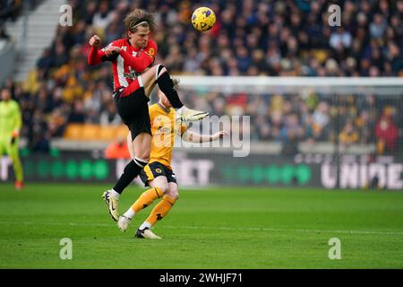 Wolverhampton, Royaume-Uni. 10 février 2024. Mathias Jensen du Brentford FC saute pour le ballon lors du match de premier League entre Wolverhampton Wanderers et Brentford à Molineux, Wolverhampton, Angleterre, le 10 février 2024. Photo de Scott Boulton. Utilisation éditoriale uniquement, licence requise pour une utilisation commerciale. Aucune utilisation dans les Paris, les jeux ou les publications d'un club/ligue/joueur. Crédit : UK Sports pics Ltd/Alamy Live News Banque D'Images