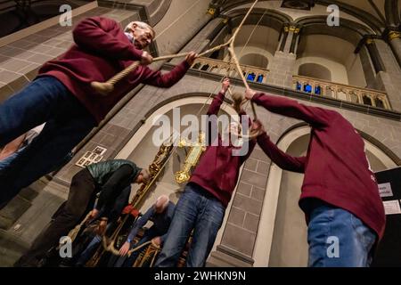 Xanten, Allemagne. 10 février 2024. Les membres de la compagnie de sonnerie tirent sur trois cordes samedi soir pour sonner les trois grosses cloches de la cathédrale. La « compagnie de sonnerie » de la cathédrale de Xanten sonne dimanche à la main 13 hommes, pour la plupart des retraités, sonnent à la main les trois grosses cloches de la cathédrale sur des cordes de 40 mètres de long. Ils suivent une chorégraphie fixe - parfois ils en pendent trois à une corde. Crédit : Christoph Reichwein/dpa/Alamy Live News Banque D'Images