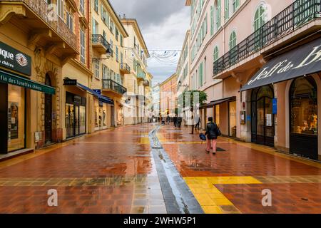 Un matin pluvieux comme les piétons marchent les rues humides devant les boutiques et les cafés dans le centre historique de Menton France, le long de la Côte d'Azur Côte d'Azur Côte d'Azur Français Banque D'Images