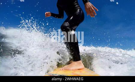 Jeune homme profitant du surf dans les vagues. Banque D'Images