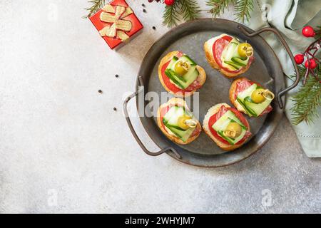 Hors-d'œuvre créatifs noël. Canapés arbre de Noël de salami, fromage, olives, tomates et concombres sur une baguette. Vue de Banque D'Images