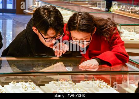 Jinan, province chinoise du Shandong. 27 janvier 2024. Les clients voient des bijoux en or dans un magasin d'or à Jinan, capitale de la province de Shandong de l'est de la Chine, Jan. 27, 2024. Crédit : Zhu Zheng/Xinhua/Alamy Live News Banque D'Images