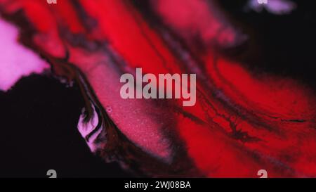 Peinture éclaboussure pailletée texture fluide encre rouge noir Banque D'Images