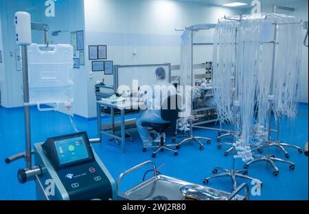 Schwerin, Allemagne. 12 février 2024. Dans la salle blanche de la société Human Med AG, des tubes sont préparés pour être assemblés dans des dispositifs médicaux de liposuccion. L’entreprise basée à Schwerin et l’Université et le Centre médical universitaire Rostock travaillent ensemble sur ce projet. Le dispositif utilise des vibrations ou un jet d'eau pour aspirer la graisse du corps humain et est utilisé dans le traitement chirurgical du lipoœdème, un trouble de la distribution de graisse. Crédit : Jens Büttner/dpa/Alamy Live News Banque D'Images